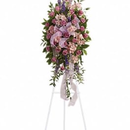 Tall standing floral spray with pink and purple flowers on an easel
