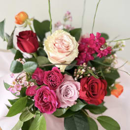 Mixed bouquet of roses in pink, red, and cream tones
