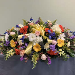 Large mixed floral arrangement with a yellow ribbon bow