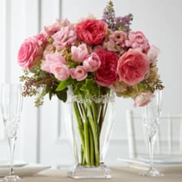 Pink and red flower bouquet in a clear glass vase