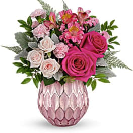 Pink and white rose bouquet in a pink textured vase