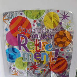 Foil balloon reading "Congratulations on your Retirement!"