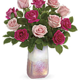 Pink and magenta roses in a tall iridescent vase