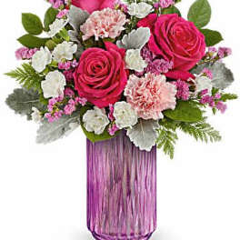 Pink roses and carnations in a purple glass vase