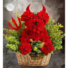 Red carnation arrangement in a wicker basket with devil horns and a trident