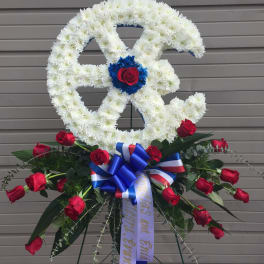 White floral peace sign with red roses and a blue ribbon