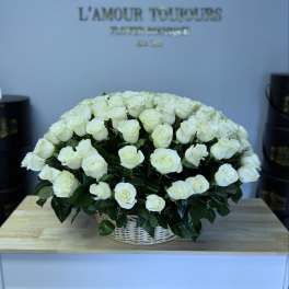 Large basket of white roses on a table
