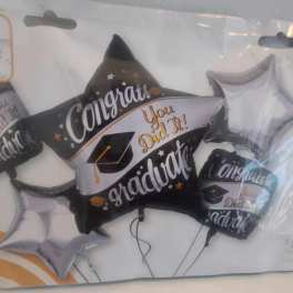 Graduation-themed foil balloons in black, white, and silver packaging