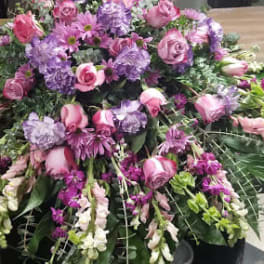 Large pink and purple floral spray on a table