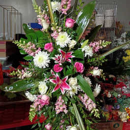 Large standing floral spray with pink and white blooms