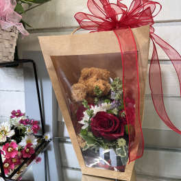 Wrapped bouquet with a teddy bear and red rose