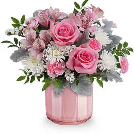 Pink roses and white daisies in a pink glass vase