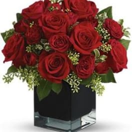 Red rose bouquet in a square glass vase