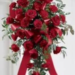 Tall bouquet of red roses with a red ribbon