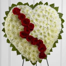 Heart-shaped white floral spray with a diagonal line of red roses