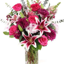 Pink roses and lilies in a clear glass vase