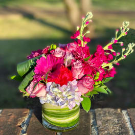 Pink bouquet in a green-striped glass vase