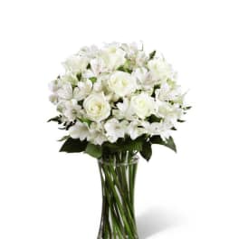 White roses and alstroemeria in a clear glass vase