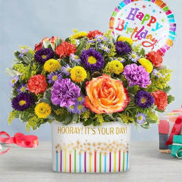 Colorful mixed flower arrangement in a birthday gift box with a balloon