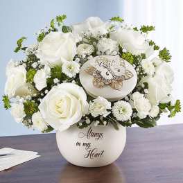 White rose arrangement in a round vase with a butterfly ornament