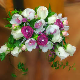 Bouquet of white and pink flowers with trailing greenery