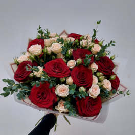 Bouquet of red and blush roses with eucalyptus wrapping