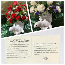 Floral arrangements with red or white flowers and small seal figurines