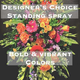 Tall standing spray with orange, pink, yellow, and purple flowers
