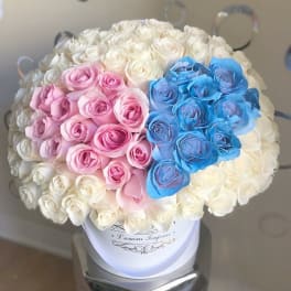 Bouquet of white, pink, and blue roses in a white hat box