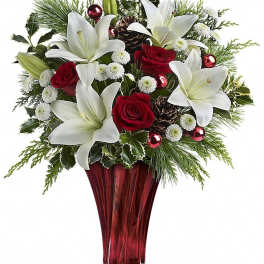 Red roses and white lilies in a red glass vase