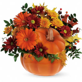Pumpkin-shaped container with orange and red flowers