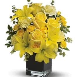 Yellow floral arrangement in a black glass vase
