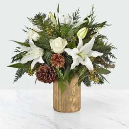 White lilies and roses in a wooden vase with pinecones