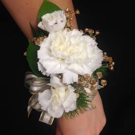 White carnation wrist corsage with gold accents and ribbon