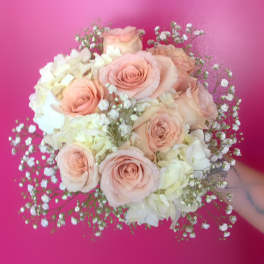 Blush roses and white hydrangeas in a round bouquet