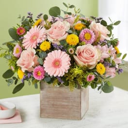 Pink roses and daisies in a wooden box arrangement
