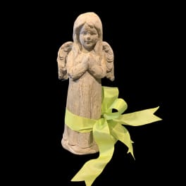 Small angel figurine tied with a yellow ribbon on a black background