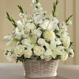 White floral arrangement in a woven basket