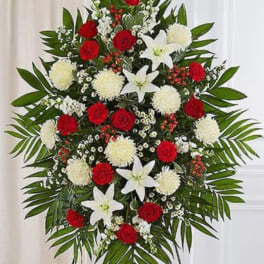 Standing floral spray with red roses, white lilies, and white pompons