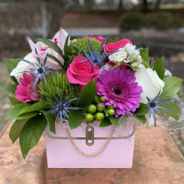 Pink and white flower arrangement in a pastel gift box
