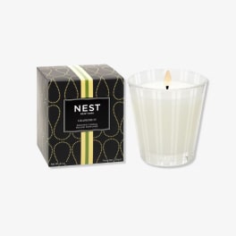 Scented candle in a glass tumbler beside its box