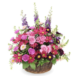 Basket arrangement of pink and purple mixed flowers