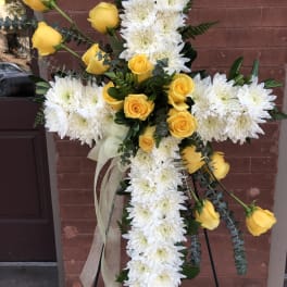 Cross-shaped floral spray with white chrysanthemums and yellow roses