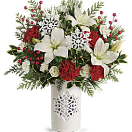 Red and white floral arrangement in a white vase
