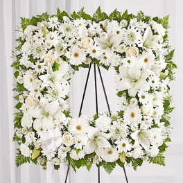 White floral wreath on a black easel