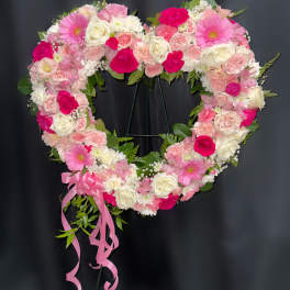 Heart-shaped floral wreath with pink and white roses and gerbera daisies