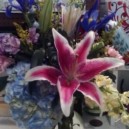 Pink stargazer lily bouquet in a clear glass vase
