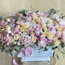 Large pastel bouquet of pink and cream roses in a white box