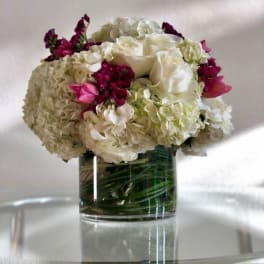 White and pink floral arrangement in a clear glass vase