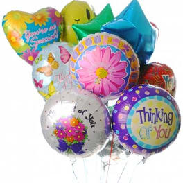 Bunch of colorful round, heart, and star-shaped mylar balloons with cheerful messages.